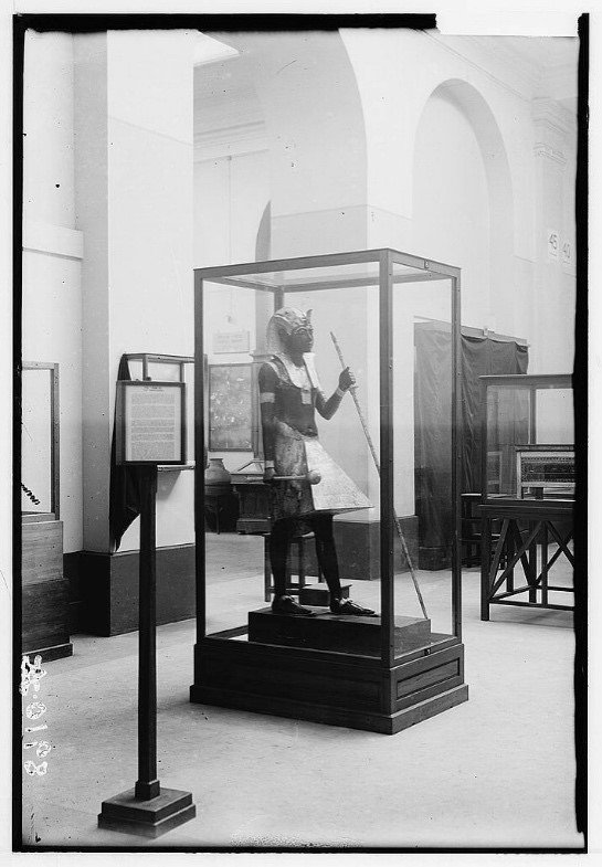 One of the guardian statues from the tomb of Tutankhamun on display in the Egyptian Musuem, Cairo, in the 1930s. Library of Congress.