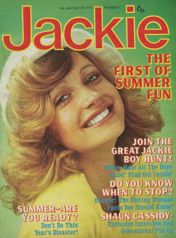 Bright and colourful front page of the1976 summer edition of Jackie magazine with a green background and the magazine&#x27;s name in large, orange letters across the top. The cover features various bits of text about the contents of the issue and girl with stylish blonde curls smiling widely as she slightly tilts her head back.