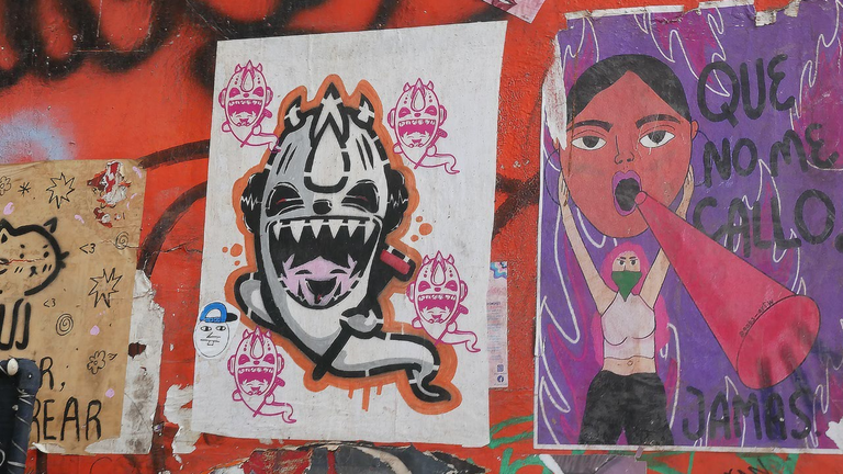 Posters and stickers on 6th Street, Pueblo, Mexico